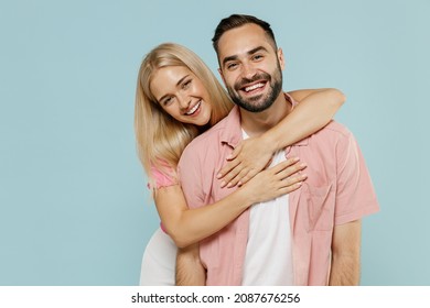 Young Smiling Happy Cheerful Couple Two Friends Family Man Woman In Casual Clothes Looking Camera Hug Together Isolated On Pastel Plain Light Blue Background Studio Portrait People Lifestyle Concept