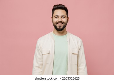Young smiling happy cheerful friendly fun european caucasian man 20s wearing trendy jacket shirt look camera isolated on plain pastel light pink background studio portrait. People lifestyle concept