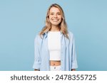 Young smiling happy cheerful fun satisfied cool woman she wearing white top shirt casual clothes looking camera isolated on plain pastel light blue cyan background studio portrait. Lifestyle concept