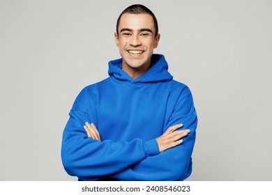 Young smiling happy cheerful middle eastern man he wears blue hoody casual clothes hold satisfied hands crossed folded look camera isolated on plain solid white background studio. Lifestyle concept - Powered by Shutterstock