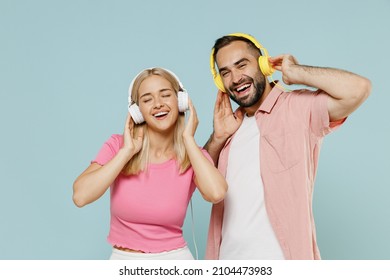 Young Smiling Happy Couple Two Friends Family Man Woman In Casual Clothes Headphones Listen To Music Together Isolated On Pastel Plain Light Blue Background Studio Portrait People Lifestyle Concept