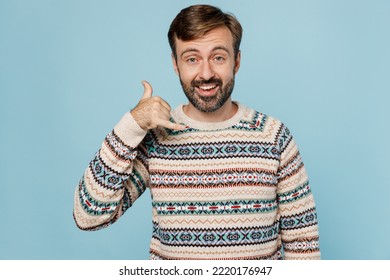 Young Smiling Happy Fun Cool Caucasian Man 30s He Wear Sweater Doing Phone Gesture Like Says Call Me Back Isolated On Plain Pastel Light Blue Cyan Background Studio Portrait. People Lifestyle Concept