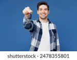 Young smiling happy man wear shirt white t-shirt casual clothes hold in hand car key fob keyless system stretch arm to camera isolated on plain blue cyan background studio portrait. Lifestyle concept