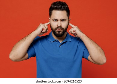 Young Smiling Happy Man Wear Basic Blue T-shirt Looking Camera Cover Ears With Hands Fingers Do Not Want To Listen Scream Isolated On Plain Orange Background Studio Portrait. People Lifestyle Concept