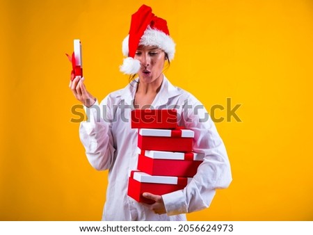 young smiling happy pretty woman holding present boxes celebrating new year, christmas gifts