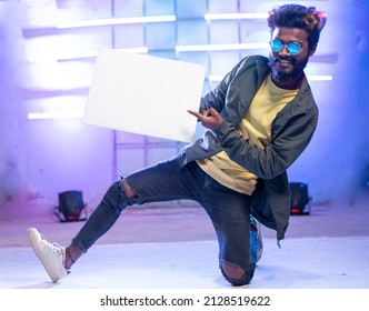 Young Smiling Hip Hop Dancer Showing White Empty Board Or Placard By Looking At Camera On Stage - Concept Of Advertisement, Ads Promotion And Professional Dancer