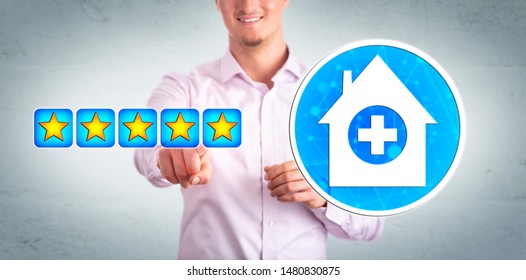 Young Smiling Male Healthcare Consumer Is Giving A Hospital Provider A Five Star Rating Online. Medicine And Technology Concept For Technology Savvy Patients, Health Care Consumerism Via Internet.