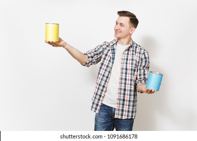 Young Smiling Man In Casual Clothes Holding Empty Paint Tin Cans With Copy Space Isolated On White Background. Instruments, Accessories, Tools For Renovation Apartment Room. Repair Home Concept