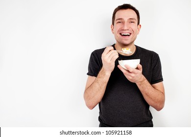 Young smiling man eating cereal on diet isolated on white background - Powered by Shutterstock