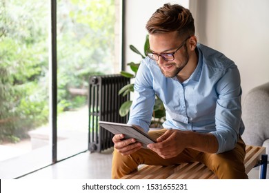 Young smiling Man looking at digital tablet