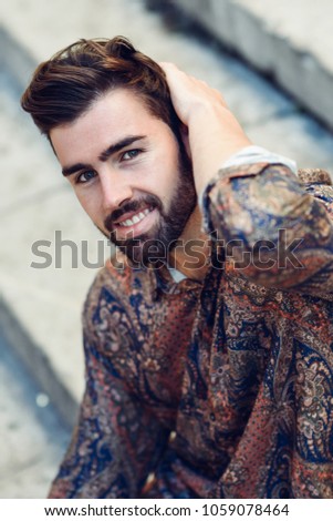 Similar – Guy with beard and modern hairstyle in urban background.