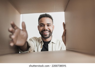 Young Smiling Man Opening Parcel, Happy Customer Open Package Indoor, Delivery And Shipment Concept.