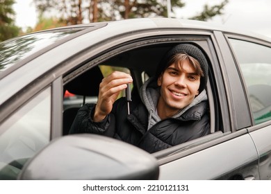 Young Smiling Man Student Holding Key Of New Car. Rent Car Or Buying First Car Concept.