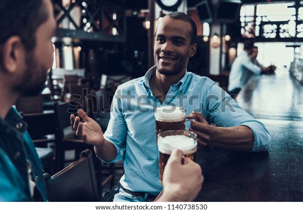 [Image: young-smiling-men-drinking-beer-600w-1140738530.jpg]