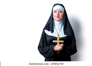 Young smiling nun with cross on white background