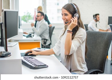 Young smiling operator woman agent with headsets working in a call center. - Shutterstock ID 1092112757