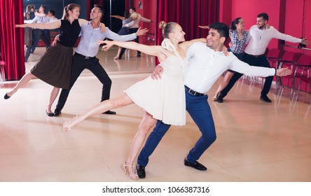 Young Smiling People Practicing Passionate Samba In Dance Class