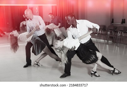 Young Smiling People Practicing Passionate Samba In Dance Class..