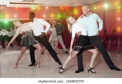 Young Smiling People Practicing Passionate Samba In Dance Class..