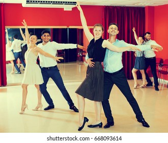 Young Smiling People Practicing Passionate Samba In Dance Class