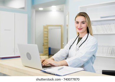 Young Smiling Receptionist In Dental Clinic