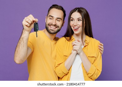 Young Smiling Satisfied Happy Fun Couple Two Friends Family Man Woman Together Wear Yellow Clothes Looking Camera Hold Car Key Fob Keyless System Isolated On Plain Violet Background Studio Portrait