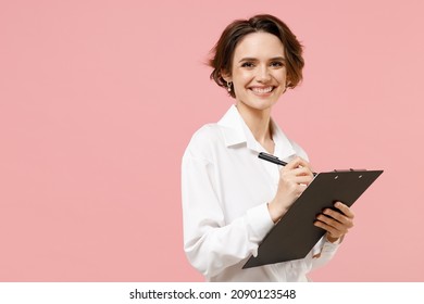 Young Smiling Successful Employee Business Secretary Woman Corporate Lawyer In Classic Formal White Shirt Work In Office Clipboard With Papers Write Document Isolated On Pastel Pink Background Studio