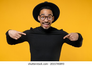 Young smiling surprised impressed shocked fun african man wear stylish black hat shirt eyeglasses point index finger on himself isolated on yellow background studio portrait. People lifestyle concept - Shutterstock ID 2015745893