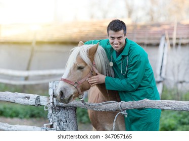 Young Smiling Veterinarian Cuddling Horse On The Ranch