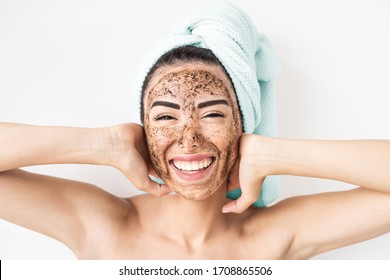 Young Smiling Woman Applying Coffee Scrub Mask On Face - Happy Girl Having Skin Care Spa Day At Home - Healthy Alternative Natural Exfoliation Treatment And People Lifestyle Concept