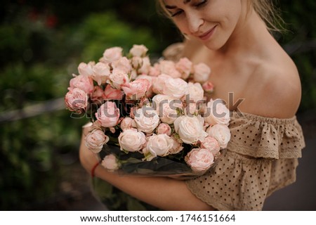 Similar – Woman arranges luxury bouquet of flowers