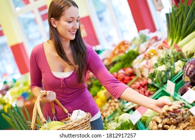 Young Smiling Woman Buys Vegetables In Health Food Store