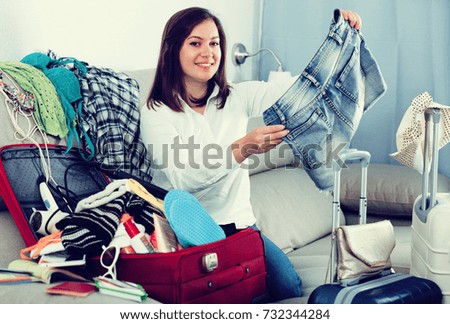 Young smiling woman getting ready for holidays at home