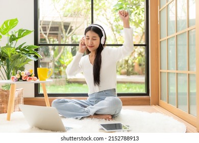 Young Smiling Woman Happy Listen Music For Chill And Relax In Summer Holiday. Lifestyle Girl Using Laptop For Entertainment In Living Room At Home.  Nature Garden Background.  Lifestyle Concept 