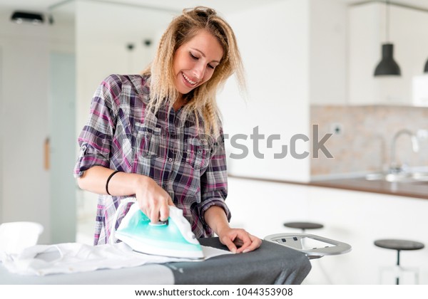 Young Smiling Woman Ironing Clothes On Stock Image Download Now