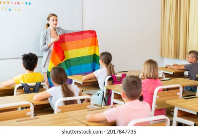 Young Smiling Woman Teacher Explaining Lgbt Theme To Children During Class In Primary School