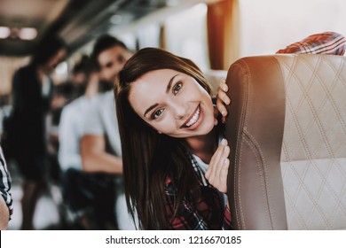 Young Smiling Woman Traveling On Tourist Bus. Happy Beautiful Woman Having Fun On Passenger Seat Of Tour Bus. Traveling, Tourism And People Concept. Friends On Trip. Happy Summer Vacation