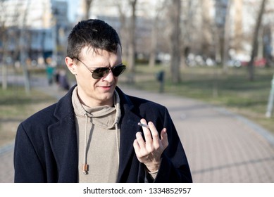 Young Smoker Man With Sunglasses Holding Smoking Cigarette In His Hand Ad Looking With Disgust Facial Expression And Bad Taste In His Mouth