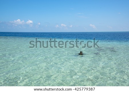 Young snorkeling in clean water over coral reef, Time to snorkeling in Maldives Beach, Maldive Island, Maldive resort