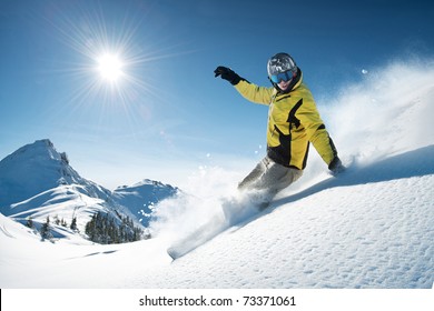 Young snowboarder in deep powder - extreme freeride