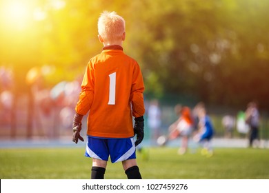 Young Soccer Goalie Goalkeeper. Young Boy Soccer Goalie. Soccer Game on Sunny Summer Day. Sport activities for children.. Football Match in the Backround. Youth Sport Wallpaper. 