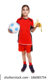 Young Soccer Player Eating Banana As Halftime Snack