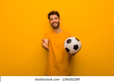 Young soccer player man reaching out to greet someone - Powered by Shutterstock