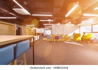 young software developers enjoying break in relaxation area of Modern sunny bright Open Plan Office
