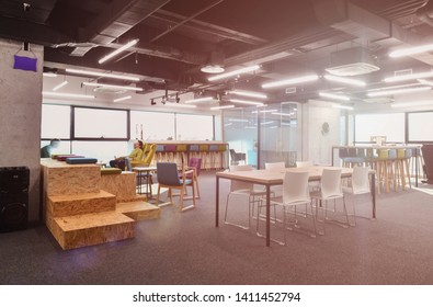 young software developers enjoying break in relaxation area of Modern sunny bright Open Plan Office