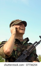 Young Soldier Calling On A Phone And Smiling