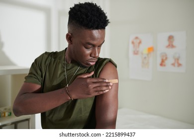 Young Soldier Covering Injection Site With Band Aid To Protect From Bacteria