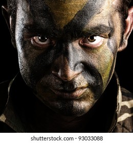 Young Soldier Face With Jungle Camouflage Paint On Black Background