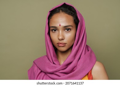 Young South Asian Woman In Headscarf Posing And Looking At Camera Isolated Over Green Wall