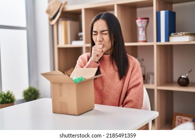 Young South Asian Woman Opening Cardboard Box Feeling Unwell And Coughing As Symptom For Cold Or Bronchitis. Health Care Concept. 